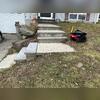 Prior to repair, soil washout had created subsurface voids beneath the concrete slabs, leading to settlement and the development of hazardous trip points. The misaligned steps presented a safety risk and required precise lifting, realignment, and stabilization to restore proper function and...