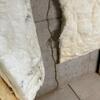 After cutting and folding back the insulation, we finally found the source of friction for Marlene! The large crack spanned from the ceiling to the floor and was slowly seeping water all down and over the basement floor.
