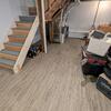 What really made this basement transformation come together was adding the gray ElitePlank flooring. It's made of inorganic materials, meaning if water ever gets into Toni's basement, the flooring won't become damaged or moldy!