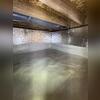 This crawl space previously lacked proper insulation, leading to cold floors and energy loss.