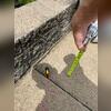 Before calling Woods, the tape measurer and string demonstrates just how unlevel the driveway was.