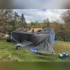 Brown Roofing's crew protected the home with tarps while removing the old roofing system and preparing the deck for new IKO Dynasty Summit Gray shingles.