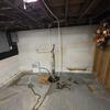 Down in Minesh's basement, water was making its way in, creating small streams throughout the space. These streams eventually led to the sump pump, but it wasn't the best route there!