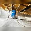 The crew takes care to encapsulate the crawl space while maintaining functionality of the appliances.