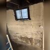 Moisture was making itself at home, but this basement was ready for a fresh start.