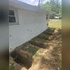 This photo shows all 5 of the push piers in their locations along the foundation of the home. You can also see some of the cracking that Addison was concerned about in the middle of the wall.