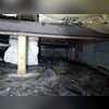 The damp crawl space before the project.