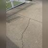 Large driveway crack extending across a concrete slab in Cerritos, California. Wide cracks like these can continue to worsen over time if left untreated and often require professional concrete repair solutions.