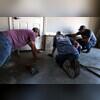 The crew worked together to lift a crack near the garage door, eliminating the tripping hazard.