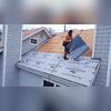 A crew member installs protective Ice & Water shield along the lower roof section. This layer helps defend the home against wind-driven rain, ice, and moisture before the shingles are added.