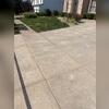 This is the driveway after the team visited. The small white splotches are where the PolyLevel was injected. The tan lines between the slabs is the NexusPro.