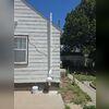 Exterior radon mitigation system with the vent pipe routed above the roofline