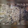 The fieldstone foundation wall exhibited a horizontal bow of up to three inches in one section, while adjacent areas showed significant stone displacement and looseness. These conditions indicated a substantial loss of structural stability, necessitating a comprehensive stabilization solution to...