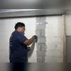 A special epoxy was used to seal cracks and prep the wall for the straps.