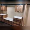 Laundry folding area with hickory cabinets and marble top.