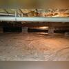 Before work began, the crawl space had exposed ground covered only by a thin vapor barrier, leaving the home vulnerable to moisture intrusion and elevated humidity.