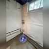 The sump pump is fully installed and ready to manage any water that enters the basement. Its reliable operation ensures homeowners won't have to worry about unexpected flooding.