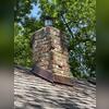 The chimney is in bad shape and needs to be fixed with several bricks that have cracked due to heavy storm damage.