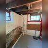 Interior radon mitigation piping professionally installed to collect radon gas beneath the foundation and vent it safely outdoors.