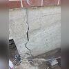 Large vertical foundation cracks and a garage wall crack extending into the ground were clear indicators that this home's foundation required professional stabilization before additional movement could occur.
