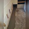 The crew re-concretes the floors. They leave a small gap between the wall and the floor, allowing water to drain into the WaterGuard system.