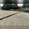 Years of settlement left multiple driveway panels uneven, creating noticeable height differences and cracking throughout the sloped entrance.
