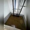 The elevator shaft experienced persistent water infiltration due to hydrostatic pressure forcing groundwater through the lowest point of the basement, raising concerns about the long-term reliability and performance of the elevator system.