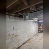 Bowing foundation wall showing vertical, horizontal, and stair-step cracking before repairs.