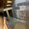 The white staining visible on the block wall is called efflorescence. This mineral deposit is a common sign that water has been moving through the masonry over time, indicating ongoing moisture intrusion that should be addressed.