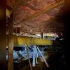 This crawl space was messy and contains sagging fiberglass, begging to be restored.