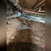 Exposed dirt floors and damaged insulation highlight the need for a full encapsulation system.