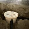 Installed in a hole at the lowest point of the crawl space, a Super Sump Plus. The Perf Pipe collects water and directs it to the pump for removal.