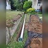 Discharge line installation in process, designed to complement the interior drainage system and prevent basement flooding.