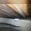 Crawl space before any of our projects. You can see dirt and debris on the floor and the mold issue on the floor joists.