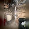 Radon mitigation piping installed within the home as part of the two-system installation.
