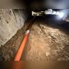 A perimeter drainage system is installed to collect water as it enters the crawl space and direct it towards the sump pump.