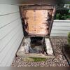 The crawl space entry door was showing severe water damage, with the wood slab on top badly rotted and deteriorated from prolonged moisture exposure.