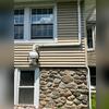 Completed exterior radon piping routed along the right side of the home.