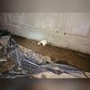 An open pipe protrudes through the foundation, adding to the severe water intrusion.