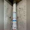 Close-up view of the existing radon piping and fittings inside the basement.