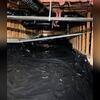 The crawl space was finished with a new perforated pipe, sump pump, and vapor barrier in place, leaving the space dry and ready to protect the home from water intrusion.