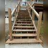 Untreated exterior wooden staircase showing severe graying and moisture exposure prior to cleaning and sealing.