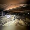 The crawl space was filled to the brim with debris with fallen fiberglass insulation, rodent fencing, dirt, and trash.
