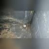 This pipe was leaking water into the space and the area surrounding it has visible water damage. 