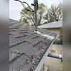 Asphalt shingles are in terrible shape. The eve is rusted out, and a repair-in-kind replacement is the best option.