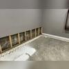 The crew removes the wet drywall and hauls it off for disposal.