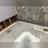 The crew digs a trench around the basement perimeter where they install the WaterGuard subfloor drainage system.