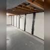 The straps are bonded directly to the foundation wall, providing reinforcement while maintaining the usable space of the basement.