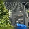 Severe paint peeling and weathered wood siding requiring professional restoration.