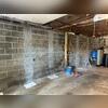 Prepping the walls to install CarbonArmor straps.